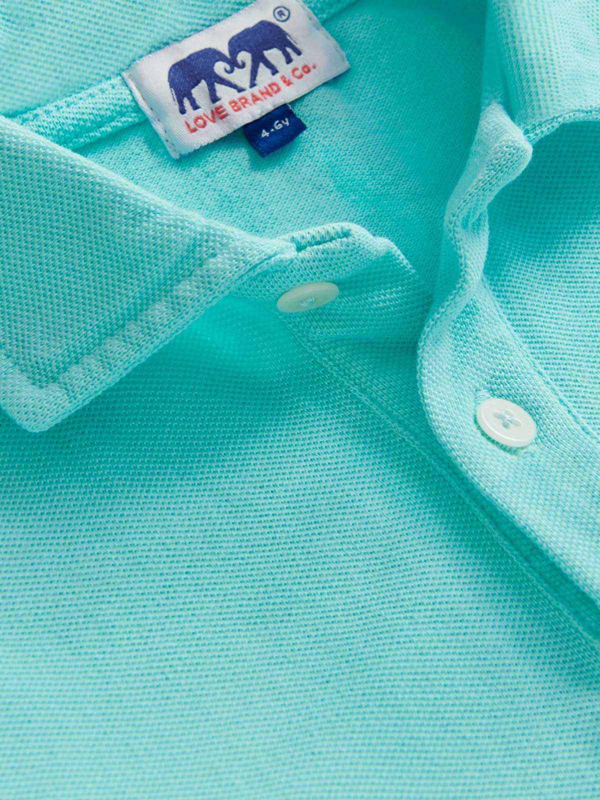 Close-up view of Kids Cay Green Pensacola Polo Shirt showcasing mint green colour.