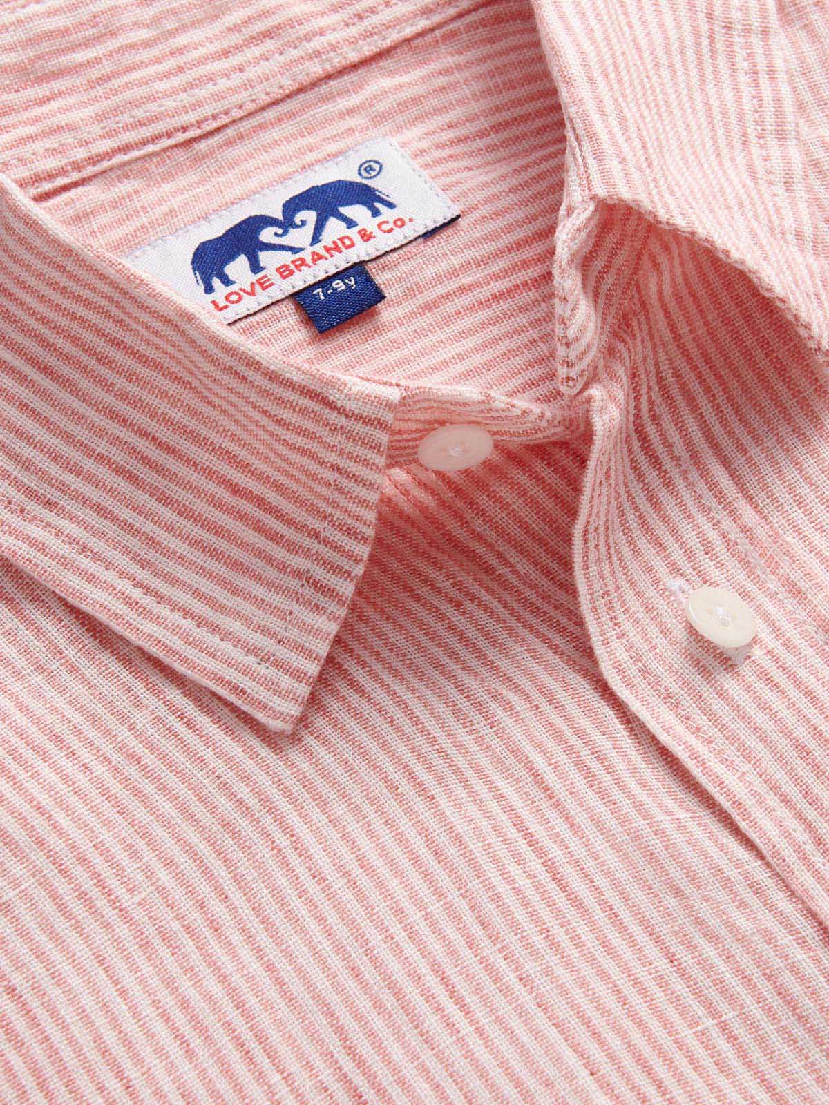 Close-up of Boys Red Lines Abaco Linen Shirt made with 100% linen, featuring a thin red stripes design with white buttons and a collar, perfect for summertime events.