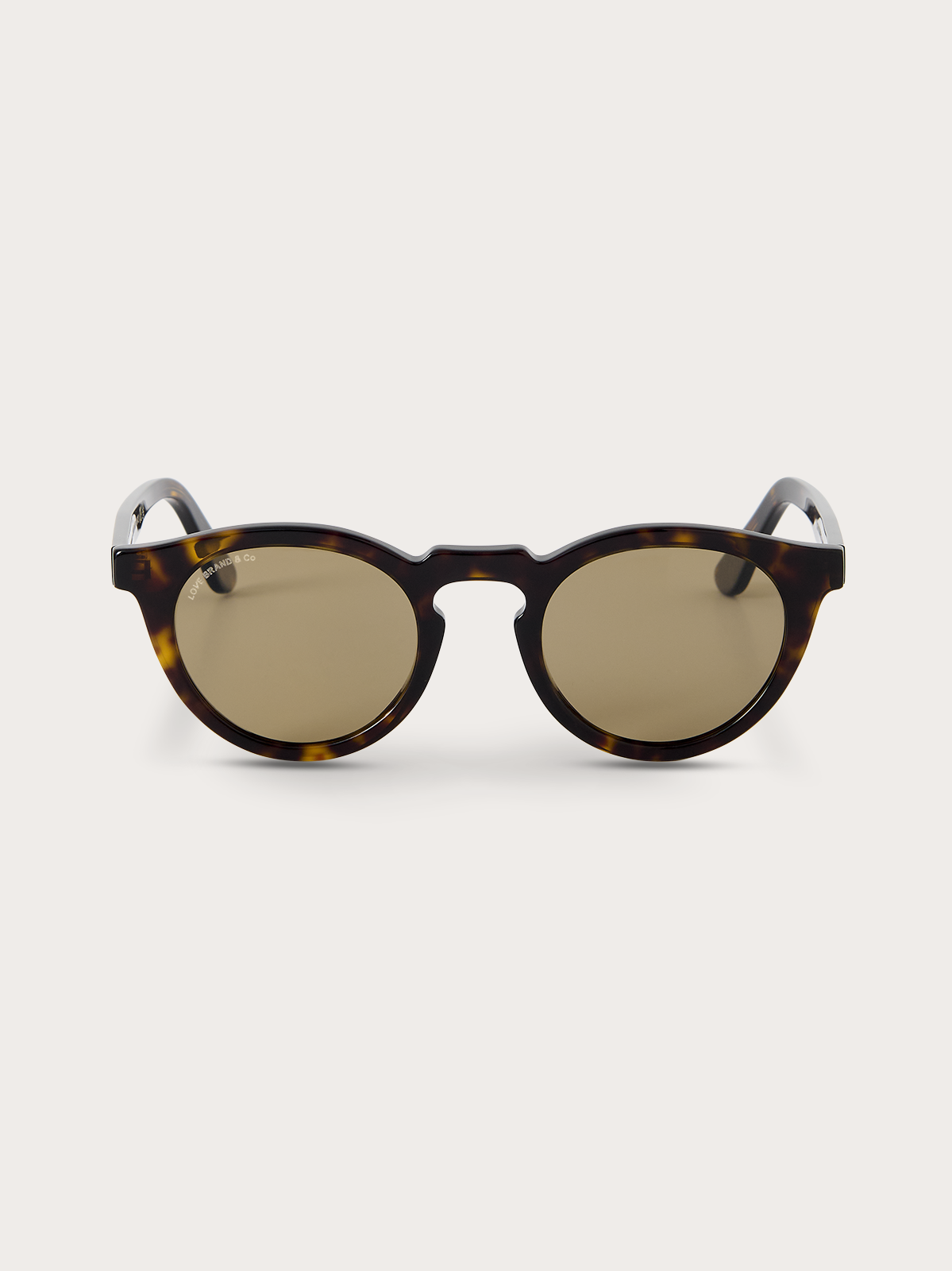 Round sunglasses with tortoiseshell frame and brown lenses on a white background