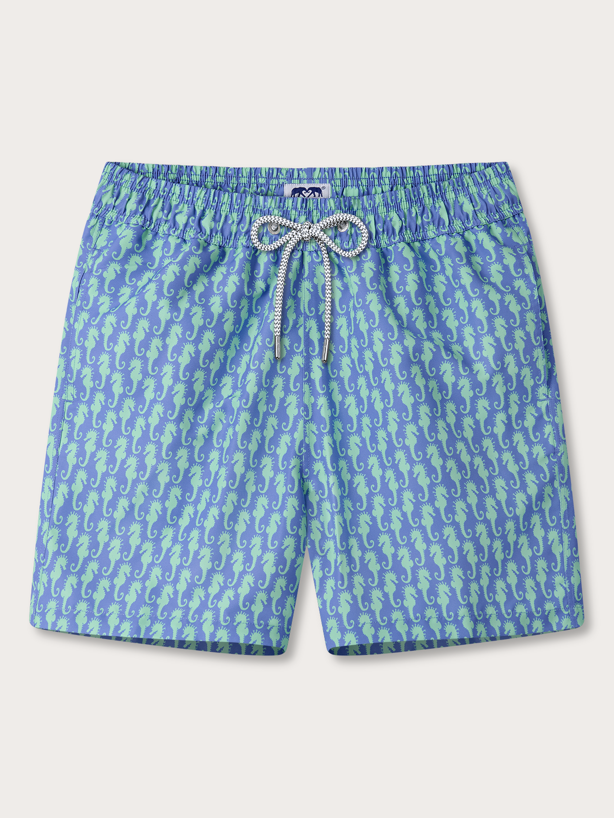 Blue swim shorts with green seahorse pattern on a white background