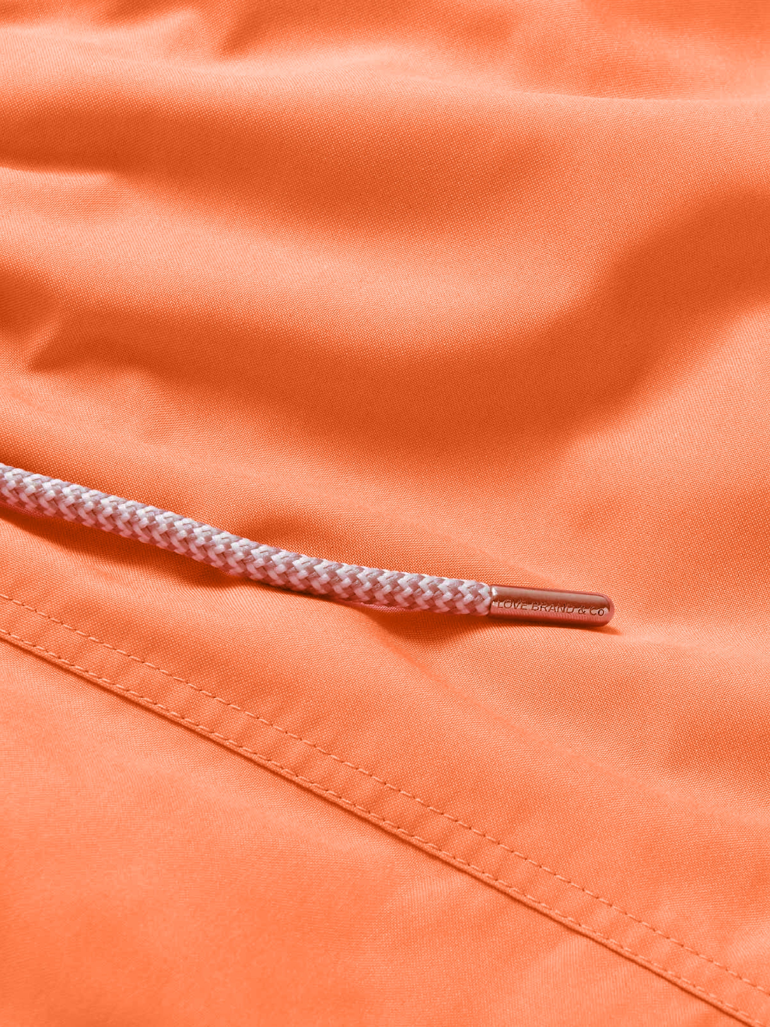 Close-up of orange fabric with a drawstring