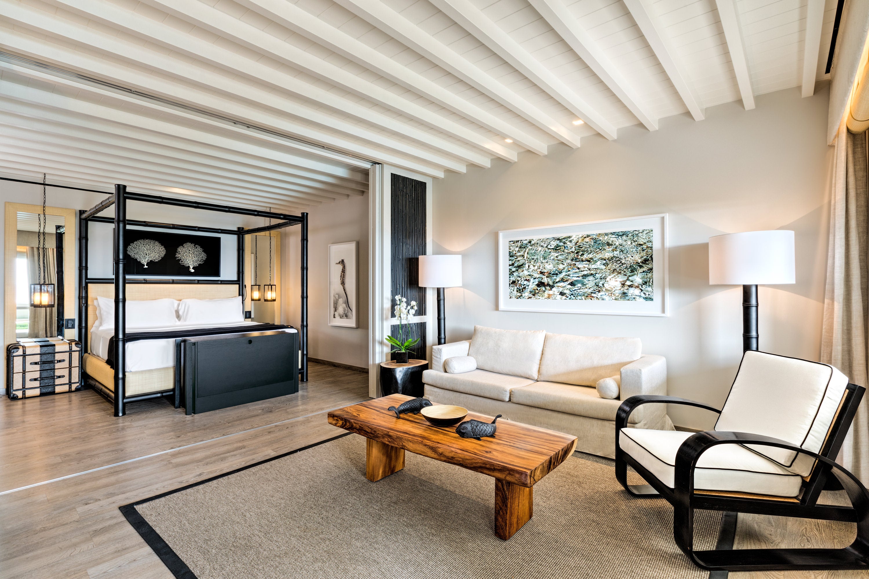 Modern bedroom with a bed, sofa, and coffee table at Santa Marian Mykonos.