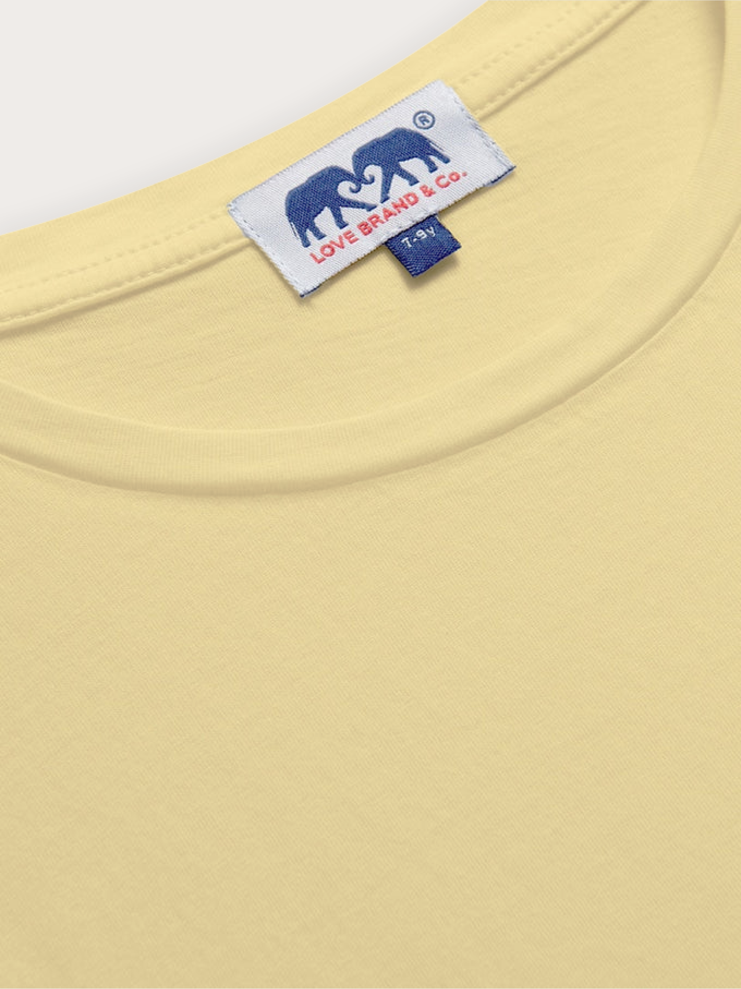 close-up of a kids yellow crew neck t-shirt with visible love brand label
