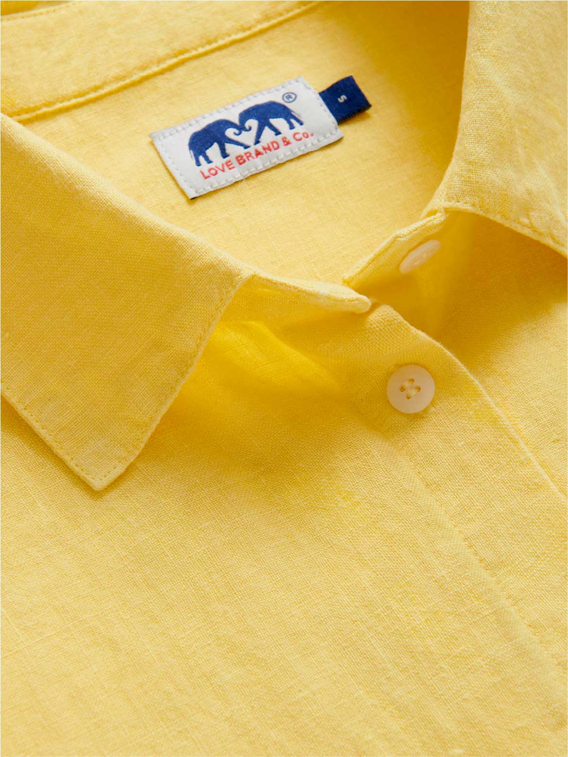 close-up collar view of womens yellow shirt