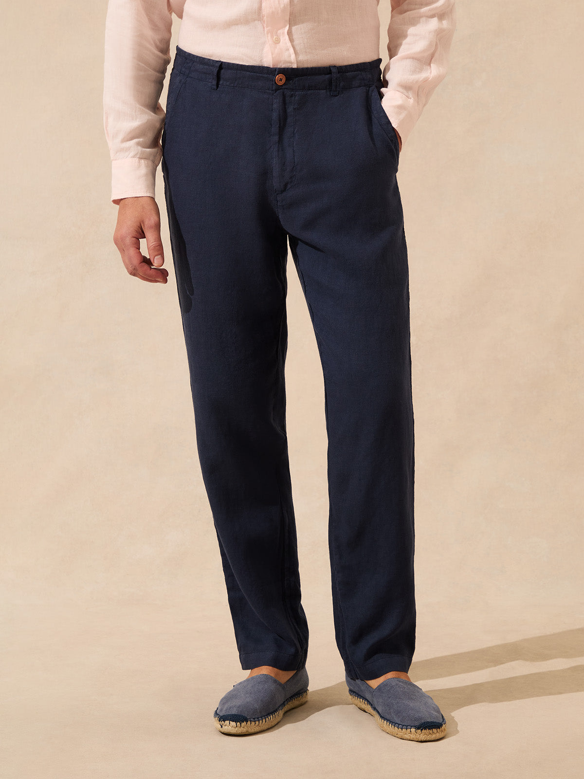 Man wearing navy linen trousers paired with matching espadrille shoes