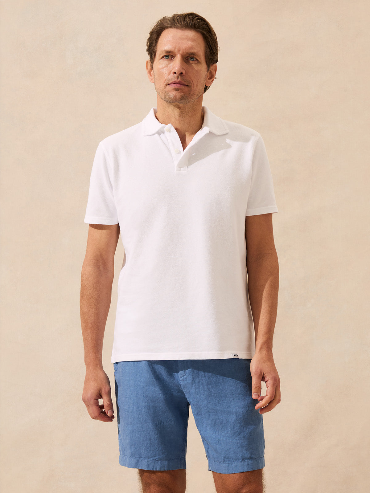 Man wearing a white polo shirt