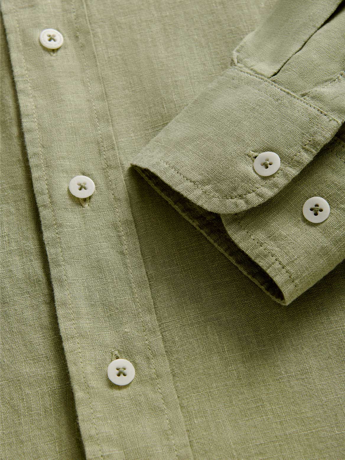 Cuff view of Men's Kerala Green Linen Shirt showing green linen fabric and cuff details.
