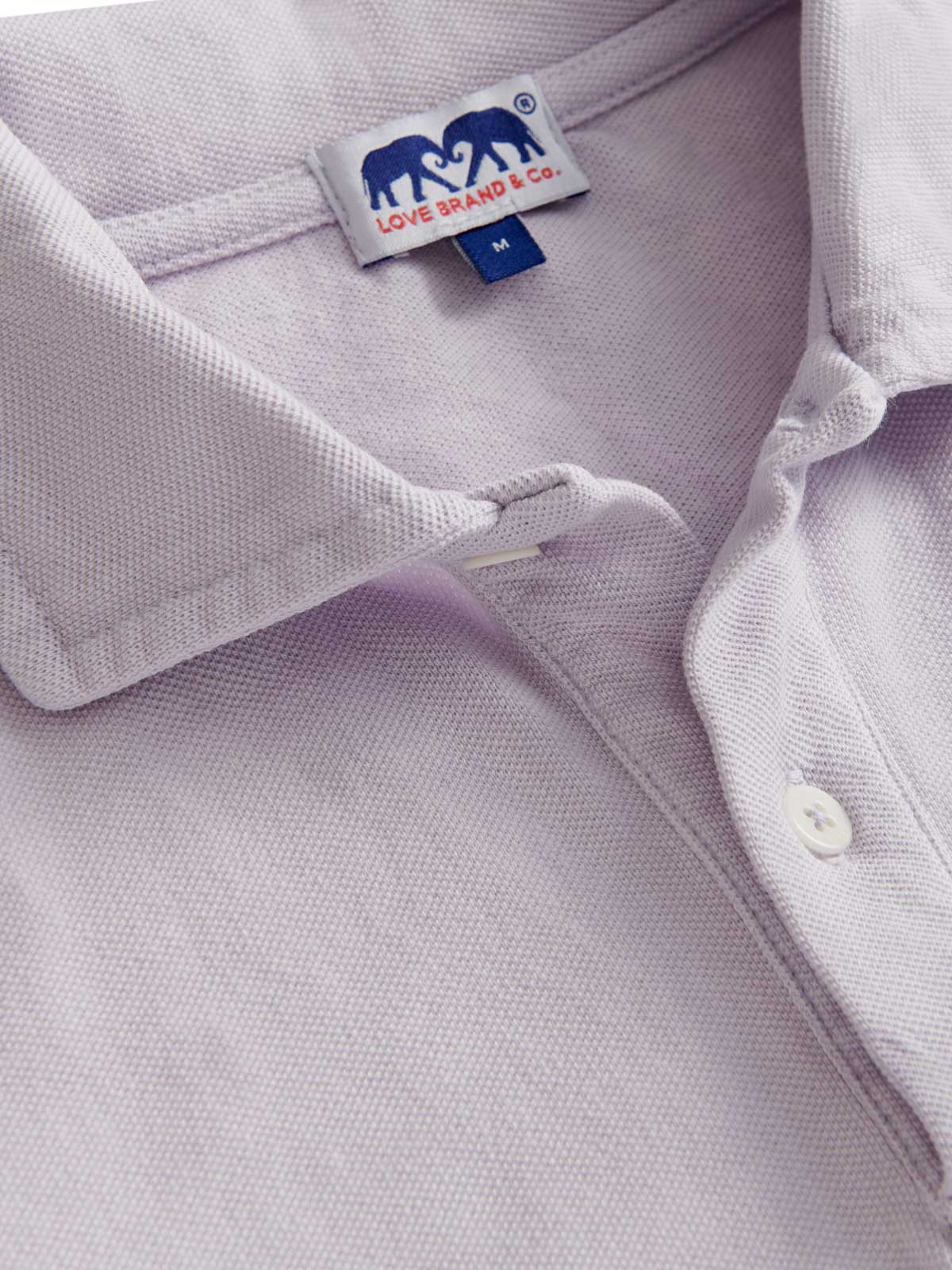 Close-up view of Men's Lavender Pensacola Polo Shirt. collar detailing of Love Brand's purple polo shirt.