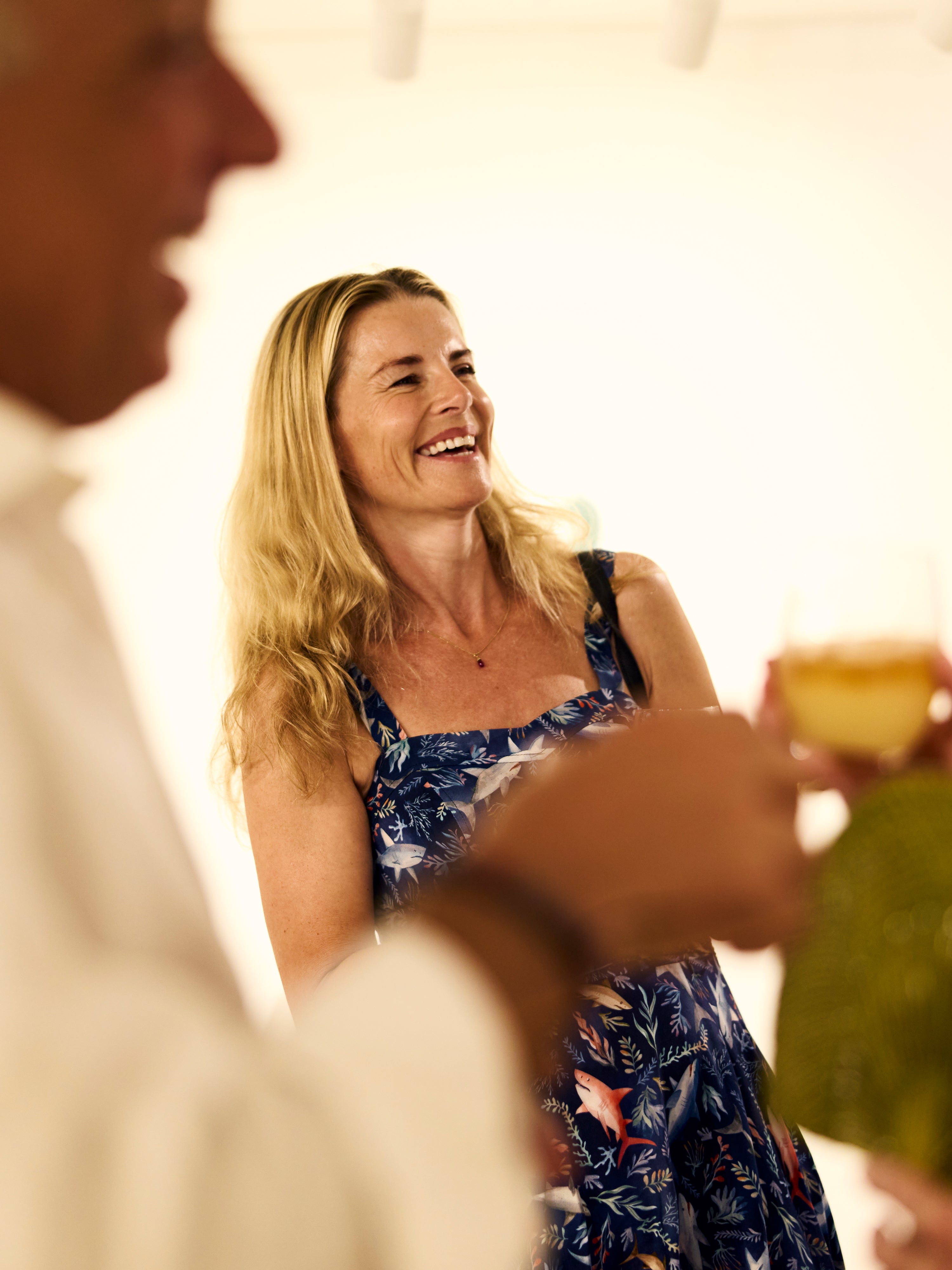 a woman smiles at love brand summer party