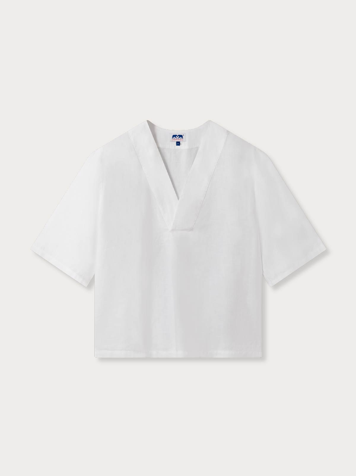 Womens v-neck white blouse with short oversized sleeves.