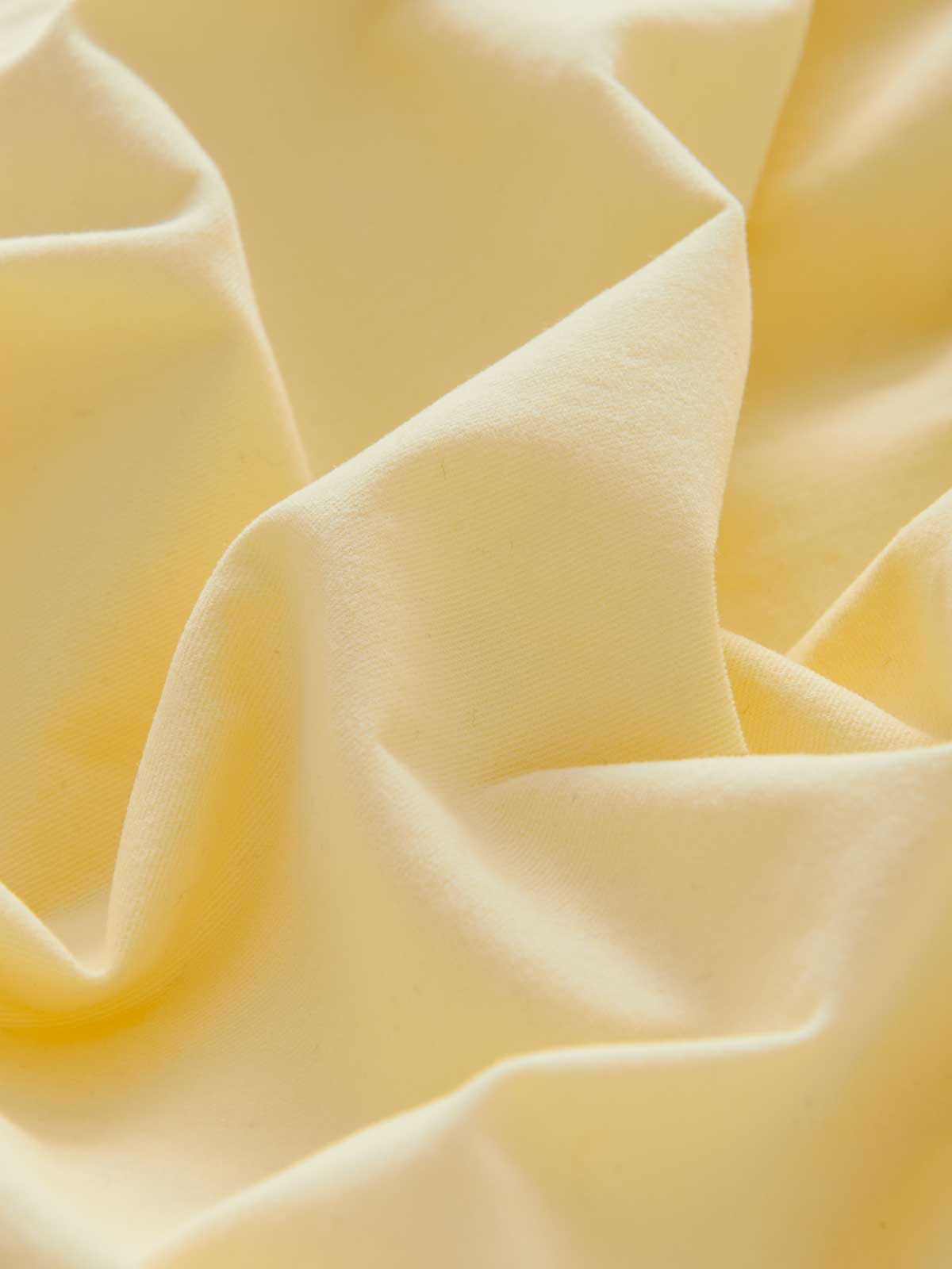 Close-up of yellow fabric with folds